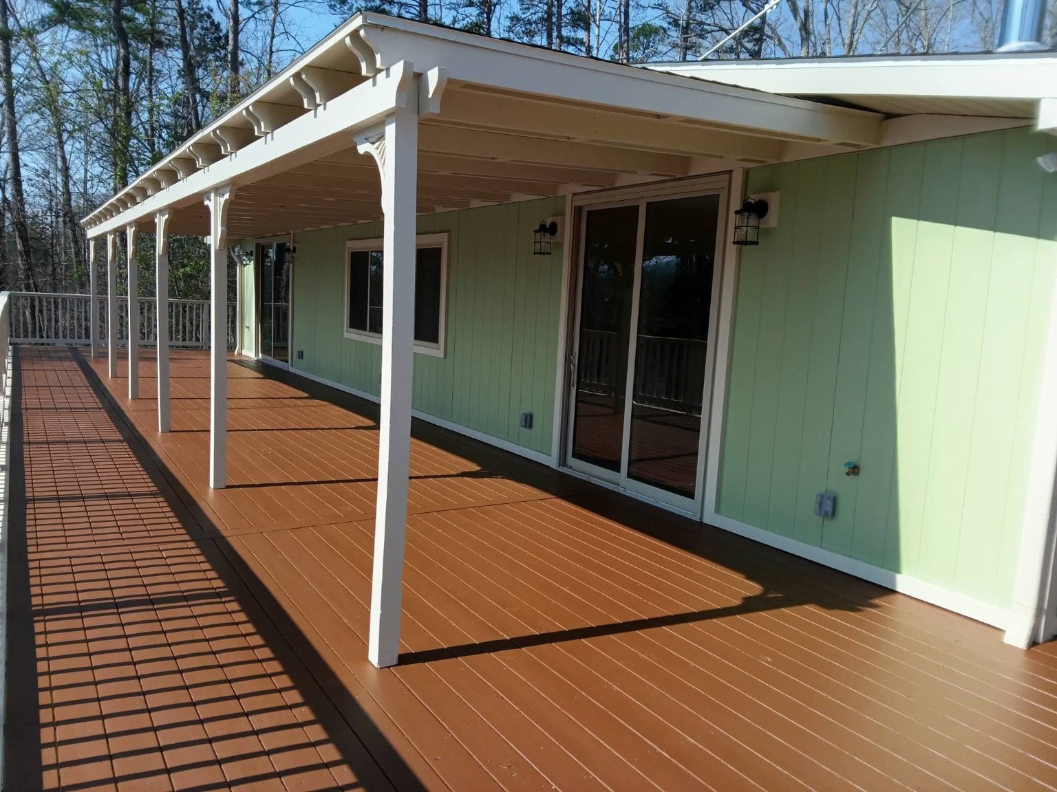Finished covered deck with stained floor and painted trim