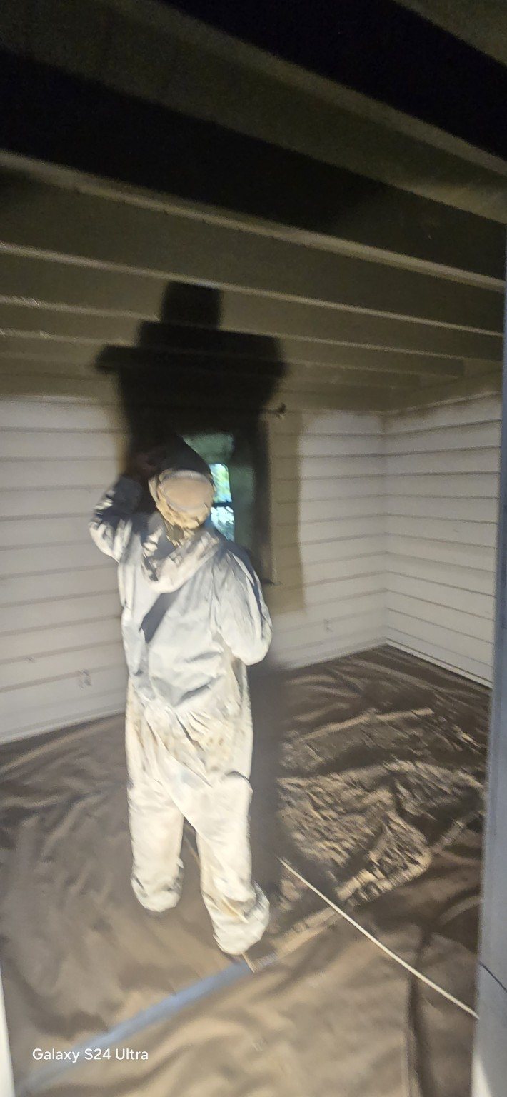 Painter working on an interior ceiling